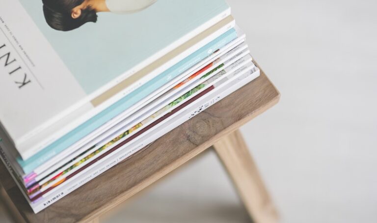 A pile of magazines stacked on a stool