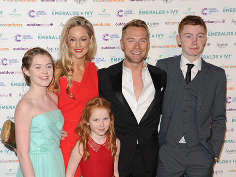 Ronan Keating and his family dressed in black tie pose for a photo as they arrive at the Emeralds and Ivy ball