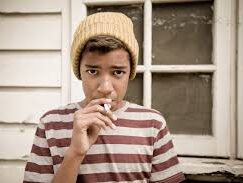 Photo of a child smoking created for a Cancer Research UK campaign to protect children through standardised tobacco packaging.